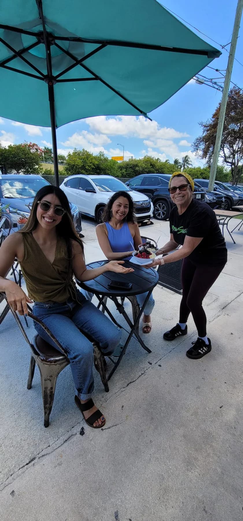 Raw South team and community moment outside the café.
