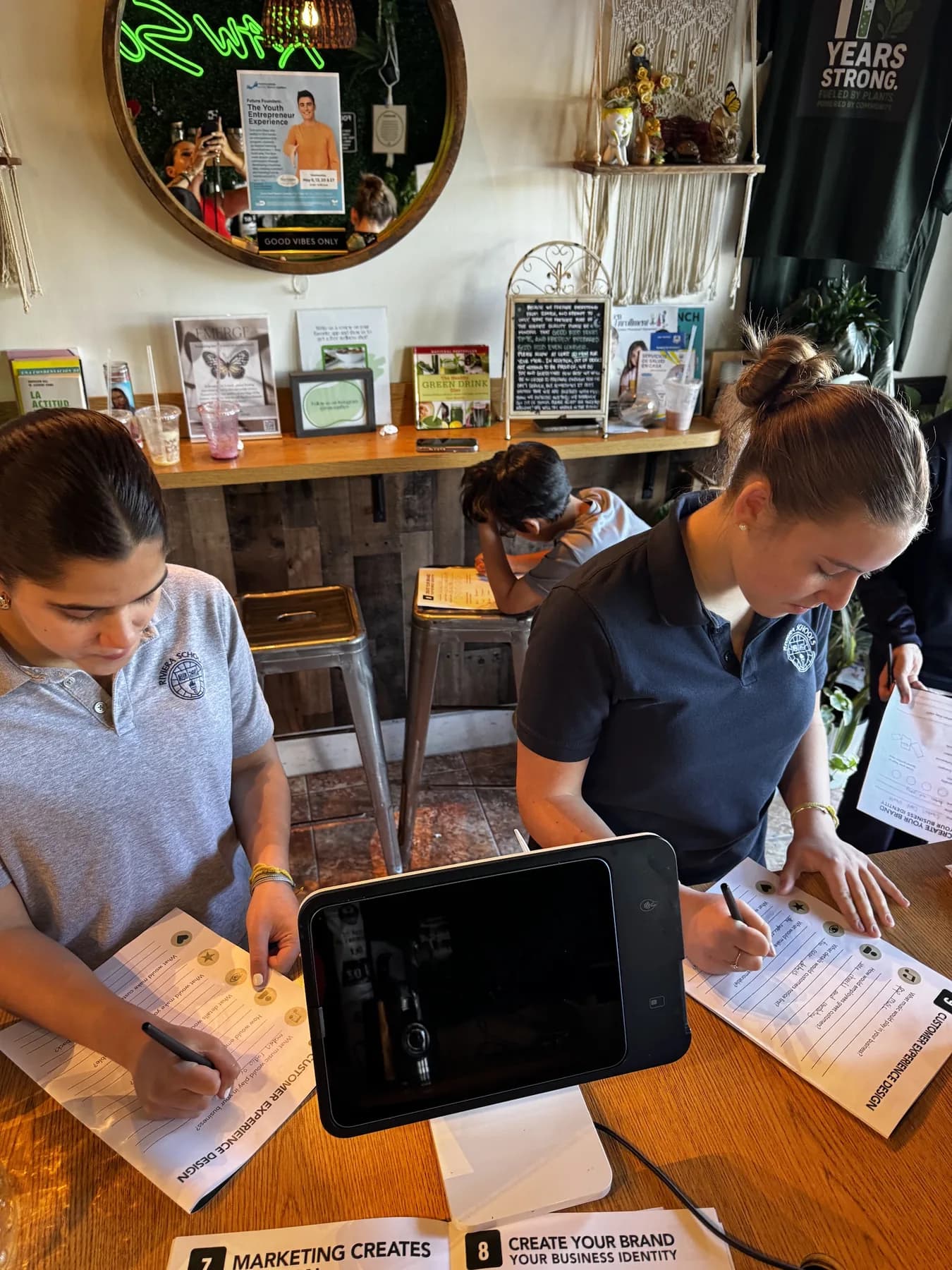 Students working at a table inside Raw South during a community learning session.