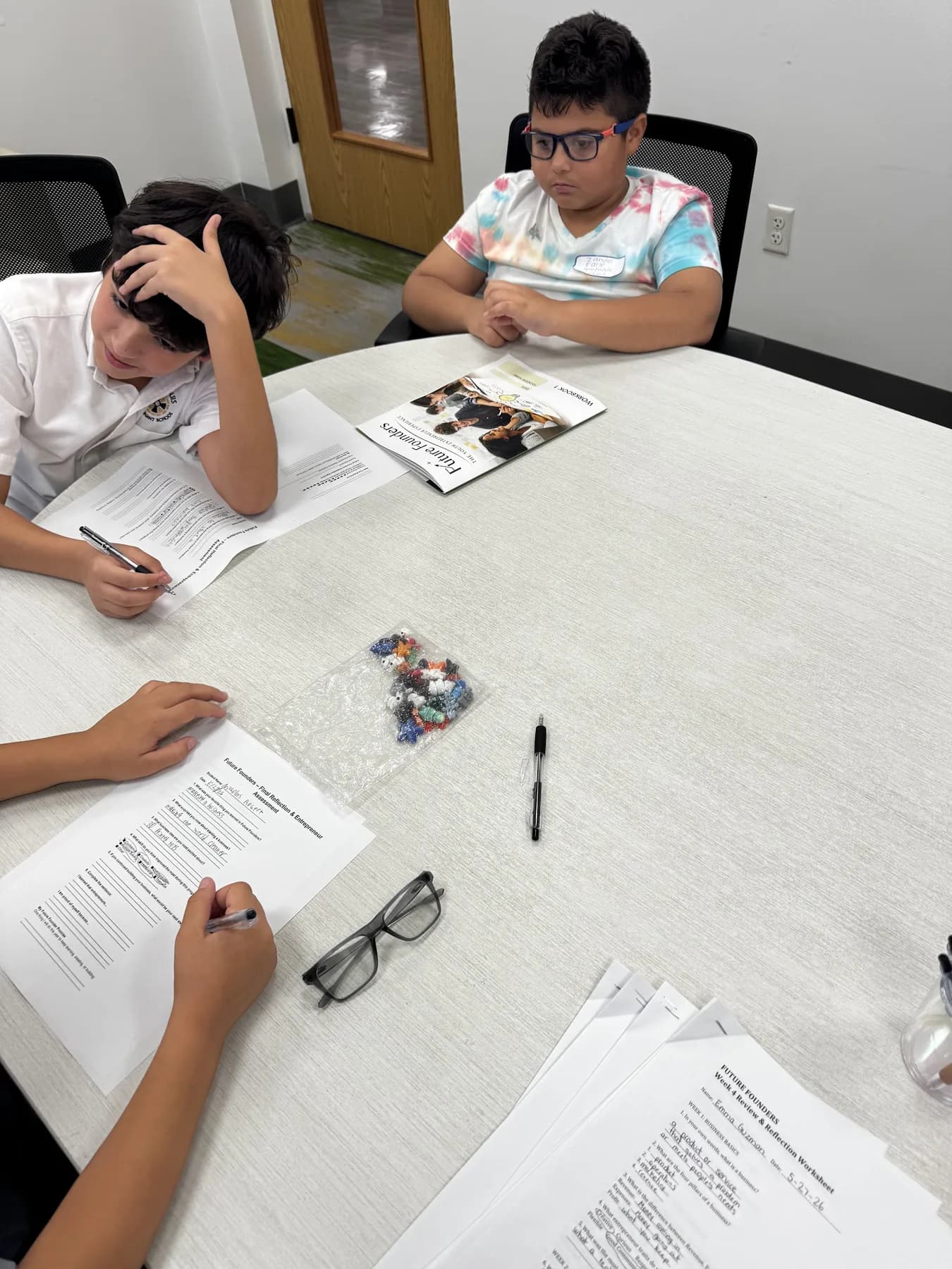 Students completing worksheets together during a Future Founders activity.